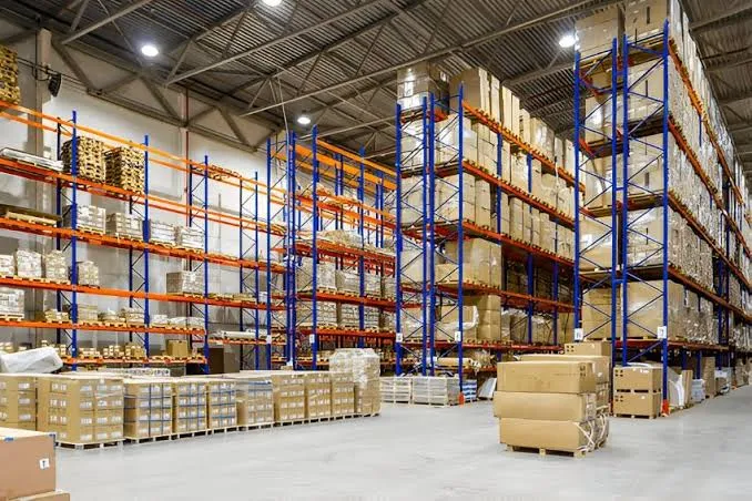 Pallets and packaged cargo stored on tall warehouse shelving